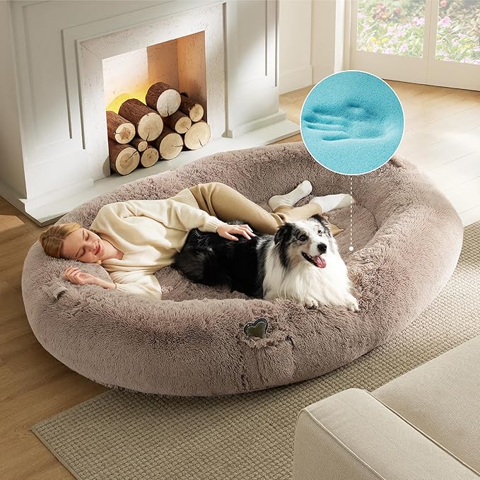 Versatile and Spacious: Step into a world of unprecedented comfort with our human dog bed for people adults, designed specifically to help you relax and destress from daily life. This cozy retreat provides ample room for cuddling, napping, reading a book, or playing games in your living room, bedroom, or office. Plus, it's portable enough for outdoor picnics or camping. It includes two side handles with velcro for easy transport and a handy pocket to store essentials.
Orthopedic Support for Superior Comfort: Experience dreamy, restorative sleep with our therapeutic human dog bed. It features soothing and warm faux shag fur supported with a layer of memory foam and a layer of high-density support foam. This innovative combination distributes weight evenly, providing optimal pressure relief and joint support for you and your pet.
Calming Bolster Design: Our human sized dog bed's bolster design offers a variety of cozy positions for snuggling and rest. The cushioned bolster, filled with chopped foam, supports your head and neck for a more restful sleep. A non-slip, studded plastic bottom ensures that the bed stays in place, providing a sense of security as you and your pet get into or out of the bed.
Waterproof & Easy to Maintain: Our bed boasts a waterproof cover that safeguards the foam from spills, water damage, and accidents, ensuring the bed remains fresh and clean. The zippered cover can be easily removed and machine washed, making care and maintenance a breeze.
Safety Assured: Rest easy knowing our bed is crafted with certified and safe materials. The foam is CertiPUR-US certified, the bed has been awarded OEKO-TEX certification, and the chopped foam is responsibly sourced from leftover mattress production foam, keeping sustainability in mind.