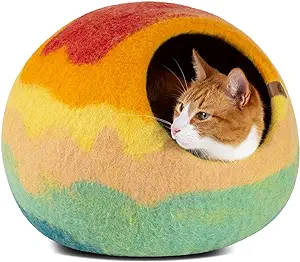 ECO FRIENDLY: Our cat tent is 100% free from harsh chemicals and synthetic materials. Great for your cat, your family, and our world.
MADE WITH LOVE: Meowfia's premium cat cave is carefully hand-crafted from 100% merino wool. It is ultra-durable, yet super soft, lightweight, and portable. Perfect gift for beloved cats and cat lovers. Since this product is made from 100% natural wool, the dimensions may slightly vary, and it is important to follow our care guidelines to keep it looking great for as long as possible! Also, if you are looking for a way to get your kitty to like their new hideaway, you can try stuffing it with your clothes first!
DUAL USE: Our felted wool cat cave provides a private personal space for your cat to hide, sleep and rest inside. But it also can be used as a cat bed to lay, relax and play on the top. Meowfia cat bed cave helps keep your kitty warm in the winter, and cool in the summer.
SLEEK DESIGN: Our cat cave house adds a special touch to your home environment and complements the appearance of the room. The natural color of the cat hideaway helps to effectively conceal the cat's fur, dust, and debris.
AVAILABLE IN MULTIPLE SIZES: Medium (M) size bed for indoor cats is suitable for an average Sphynx, Abyssinian, Exotic, and other similar-sized breeds. The maximum cat weight for M size cat hideout is up to 12 lbs, whereas L size cat cave indoor (also available from Meowfia's Amazon store) is perfect for cats weighing up to 20 lbs. We suggest choosing the larger size of the cat bed mat if your cat is somewhere between sizes M and L.