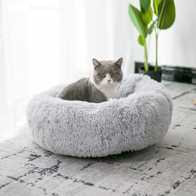 BODISEINT Modern Soft Plush Round Pet Bed for Cats or Small Dogs, Mini Medium Sized Dog Cat Bed Self Warming Autumn Winter Indoor Snooze Sleeping Cozy Kitty Teddy Kennel (20'' D x 8'' H, Light Grey)

Material:Make of attractive luxurious faux fur,macarons color donut shape.Round pet bed offers a safe, Ideal for a cat or small dog to snooze.Your little furry friends will feel surrounded by love and warmth, allowing them to experience truly restful sleep. restful sleep for improved behavior and better health.
Choose size: We suggest the 20" D x 8" H (S) bed for pets of small size up to 20lbs.Suit :for all age of cats,small dog breeds puppy Chihuahua,Yorkshire,Schnauzer,Poodle,Bichon Frise,Miniature Pinscher.
COMFORT AND SUPPORT: Filled with a high-loft recycled polyester fiber.Self warming fleecy fabric keeps your kitty or doggy warmer in winter.
Water-resistant and non-skid bottom:Small pet bed's non-skid dirt resistant bottom keeps pet bed in place for worry-free placement on tile and hardwood floors in the home/living room .
The cover can not be removable:To avoid matting of the fur, it is important that the bed is thoroughly dried in DRYER directly after washing. Do NOT AIR DRY.